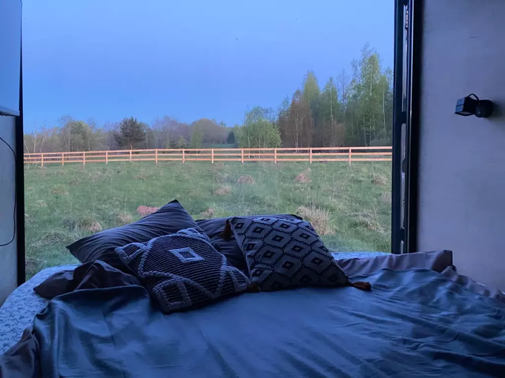 Маленький дом «Свидание на двоих» с панорамным окном до 2 гостей: вид на луг из кровати